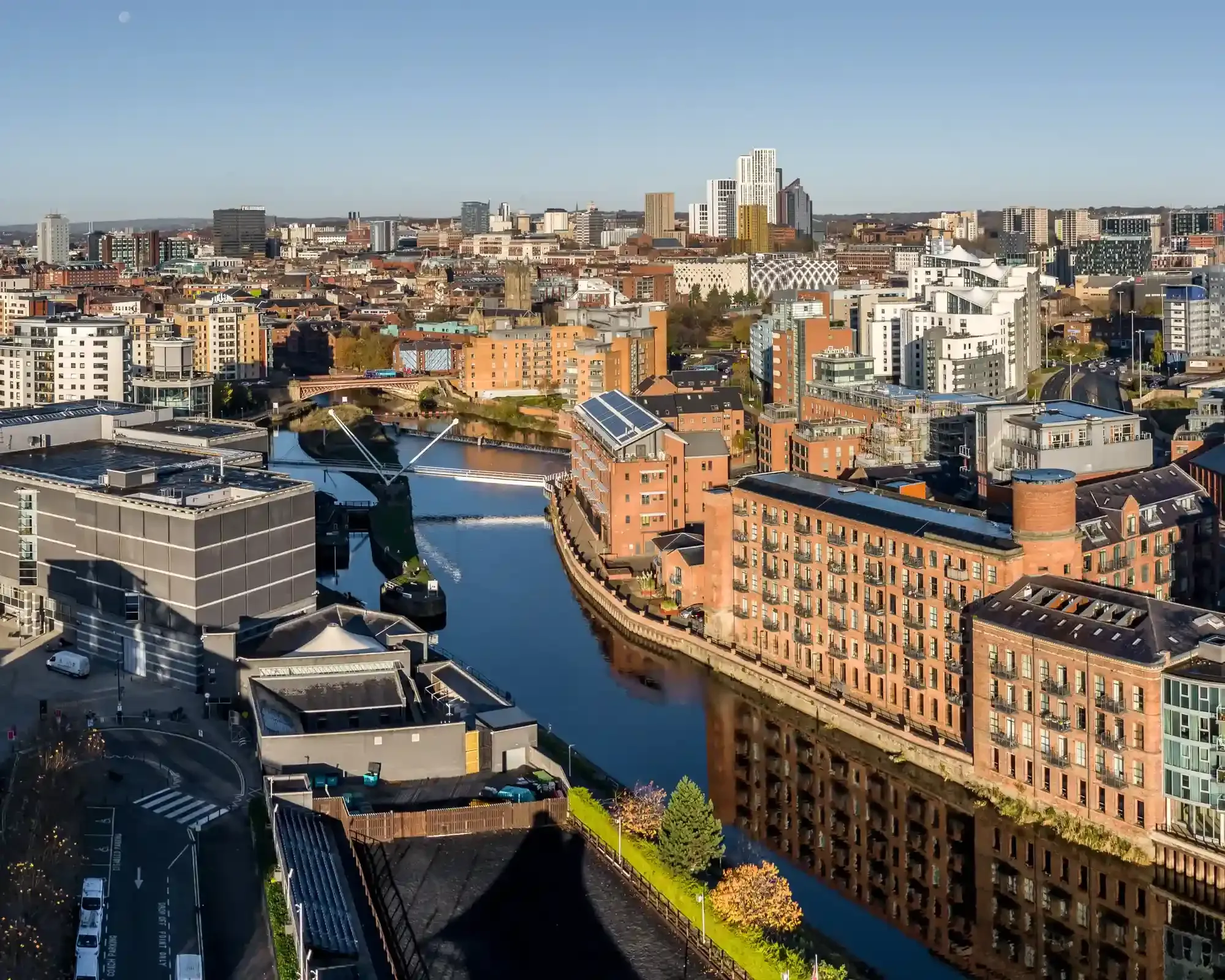 Aerial view of Leeds city centre skyline along the River Aire